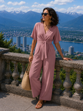Mono mujer elegante con escote cruzado y pantalón de pierna ancha